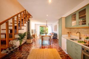 a kitchen with a sink and a table in it at Country chic duplex in Algarve in Pêra