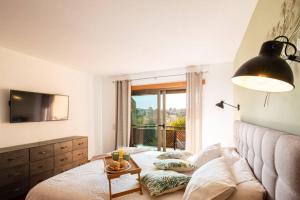 a bedroom with a bed and a large window at Country chic duplex in Algarve in Pêra +13 photos