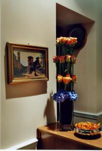 a vase filled with flowers on top of a table at Hotel Magic in Rome