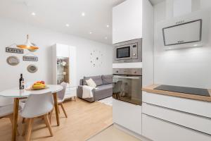 a kitchen and a living room with a table at Apartment Opa Gold in Rijeka
