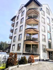 a white building with balconies on it at Lux Apartman Boris in Zlatibor