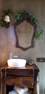 a bathroom with a sink and a mirror at Herdade do Moinho Novo in Canha