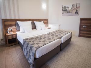 Posteľ alebo postele v izbe v ubytovaní Hotel Miodowa