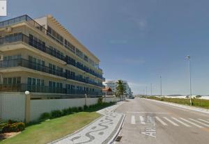an empty street in front of a large building at Las Dunas in Cabo Frio