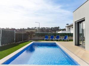 a swimming pool in the backyard of a house at Luxury villa with private heated pool in Foz do Arelho
