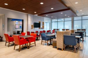 A television and/or entertainment centre at Holiday Inn Express & Suites - Romeoville - Joliet North, an IHG Hotel