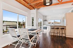 a kitchen and dining room with a table and chairs at Port Central No 2 in Port Campbell