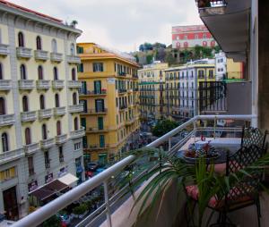 einen Balkon mit Stadtblick und Gebäuden in der Unterkunft WELL COME - Palazzo Reale in Neapel