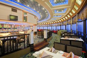 a restaurant with tables and chairs and a bar at Holiday Inn Hefei by IHG in Hefei