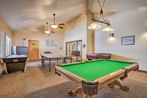 a living room with a pool table and ping pong ball at Brian Head Ski-InandSki-Out Condo with Resort Perks! in Brian Head