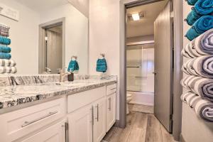 a bathroom with two sinks and a toilet at Brian Head Ski-InandSki-Out Condo with Resort Perks! in Brian Head +24 photos