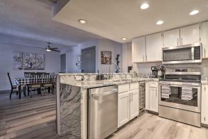 a kitchen with stainless steel appliances and a dining room at Brian Head Ski-InandSki-Out Condo with Resort Perks! in Brian Head