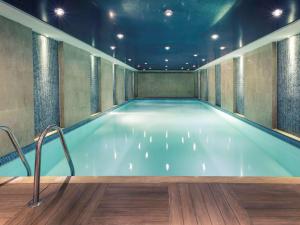 a large swimming pool in a building with at Mercure Istanbul Umraniye in Istanbul