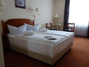 Mercure Hotel Plaza Magdeburg tesisinde bir odada yatak veya yataklar