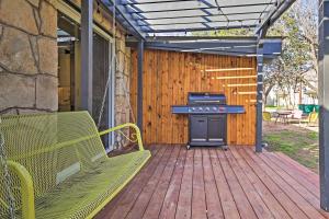a patio with a grill and a bench on a deck at Retro Updated Blanco Abode - Steps to Main Street! in Blanco