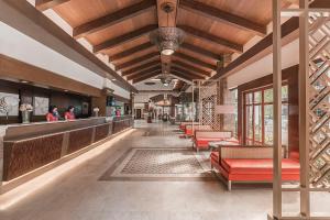 a lobby of a restaurant with red chairs and a bar at Henann Regency Resort and Spa in Boracay