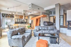 a living room with two couches and a table at Dwtn Condo Walk to Stadiums, Museums, Bars and More in Cleveland