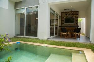 a house with a swimming pool in front of a house at Modern House Surrounded By Nature in Mérida