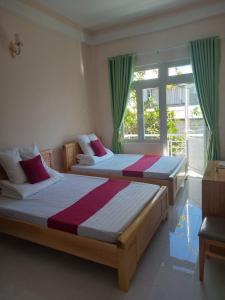 Postel nebo postele na pokoji v ubytování Mango Hotel Dalat