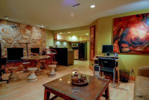 a living room with a large painting on the wall at House On Dunbar B&B in Vancouver