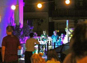 a group of people watching a band on a stage at Voyage Recoleta Hostel in Buenos Aires