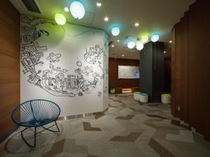 a room with a wall with a drawing on it at KOKO HOTEL Ikebukuro East in Tokyo +81 photos
