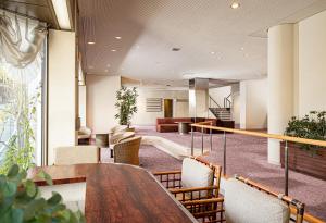 a lobby with a table and chairs and a couch at The Gran Resort Elegante Atami in Atami