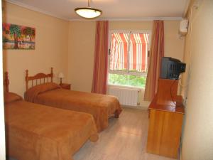 Postel nebo postele na pokoji v ubytování Hostal Imperial