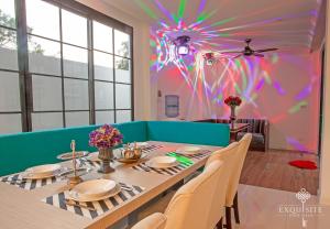 a dining room with a table and a colorful wall at Pool Villa Pattaya 5BD - Exquisite Pool Villa G in Nong Prue