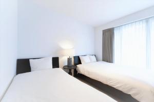 Postel nebo postele na pokoji v ubytování SALON Shibuya