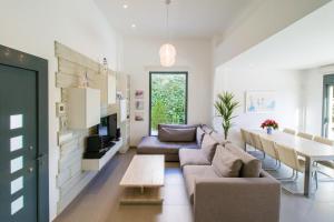 a living room with a couch and a table at Villa de lujo Rojales in Rojales