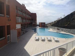 a swimming pool on the balcony of a building at Home Sweet Home with Ocean View in Costa Calma