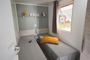 a bedroom with a bed and a window at Camping International in Calvi