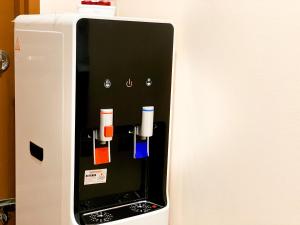 um frigorífico com várias garrafas coloridas diferentes sobre ele em Carlsun Hotel em Kulai