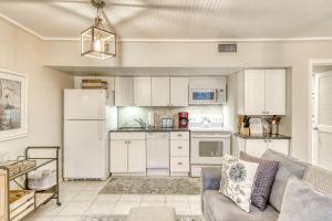 a kitchen with white appliances and a couch in a room at Mariner's Watch 4250 in Kiawah Island