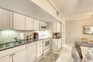 a kitchen with white cabinets and a sink at Mariner's Watch 4250 in Kiawah Island