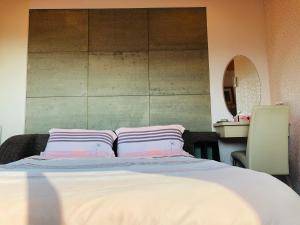 a bedroom with a bed with two pillows on it at Chong Er Ya She Homestay in Jiji