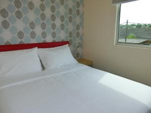 Postel nebo postele na pokoji v ubytování Carlsun Hotel