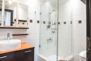 a bathroom with a glass shower and a sink at #Mary Rose Apt by halu! Apartments in Thessaloniki