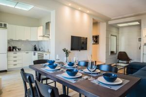 a dining room with a table and chairs and a kitchen at #Mary Rose Apt by halu! Apartments in Thessaloniki