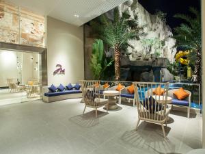 a lobby with chairs and a dinosaur wall at Mercure Pattaya Ocean Resort in Pattaya Central