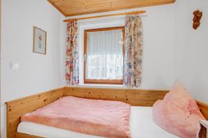 a small bedroom with a bed and a window at Ferienwohnung König im Erdgeschoss in Berchtesgaden
