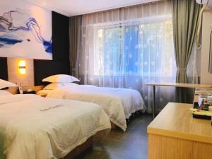 Katil atau katil-katil dalam bilik di  Shenzhen Hualian Boutique Hotel