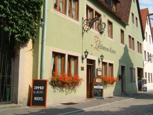 a building with flowers on the side of a street at Ferienwohnungen Monteurzimmer zur Silbernen Kanne in Rothenburg ob der Tauber