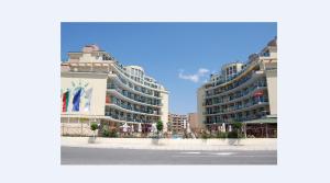 two tall apartment buildings on a city street at Julia Family Apartments in Sunny Beach