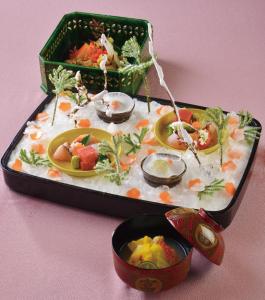 a tray of food sitting on a pink table at The Gran Resort Princess Arima in Kobe