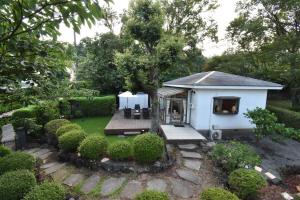 a small white shed with a grass yard at KandoStay 伊豆高原パークガーデン in Ito +58 photos
