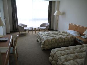 Letto o letti in una camera di The Gran Resort Arima