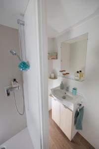 a bathroom with a sink, toilet and shower at Camping International in Calvi