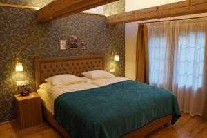 a bedroom with a large bed with a blue blanket at Hotel Walliserhof Zermatt in Zermatt